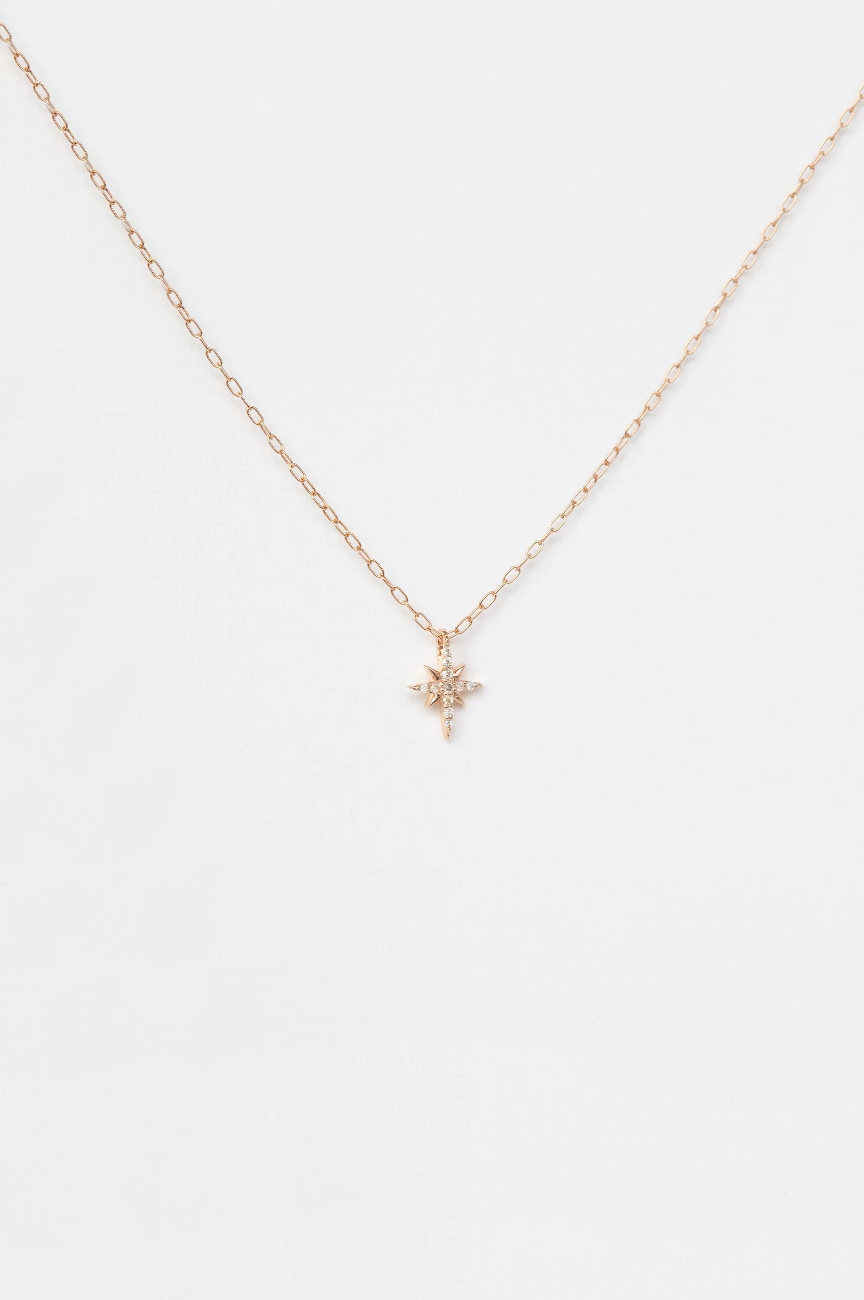 rose gold fine chain necklace with a small eight-pointed north star pendant pavé-set with round brilliant diamonds