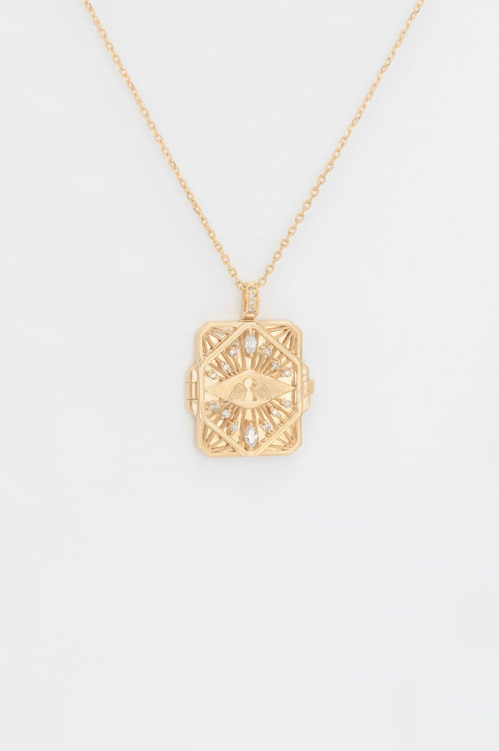 Gold necklace geometric book pendant eye motif diamond accents Celine Daoust