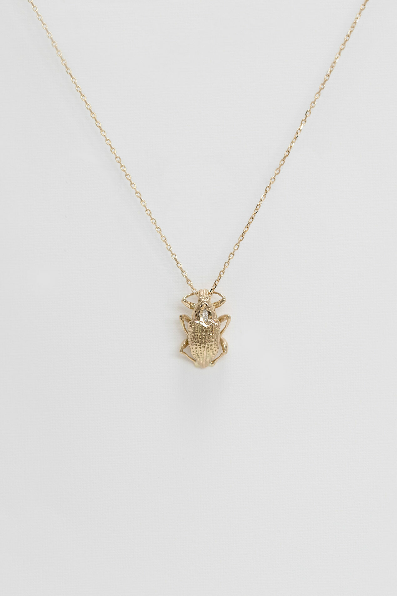 Gold necklace sculpted scarab charm marquise diamond accent Celine Daoust