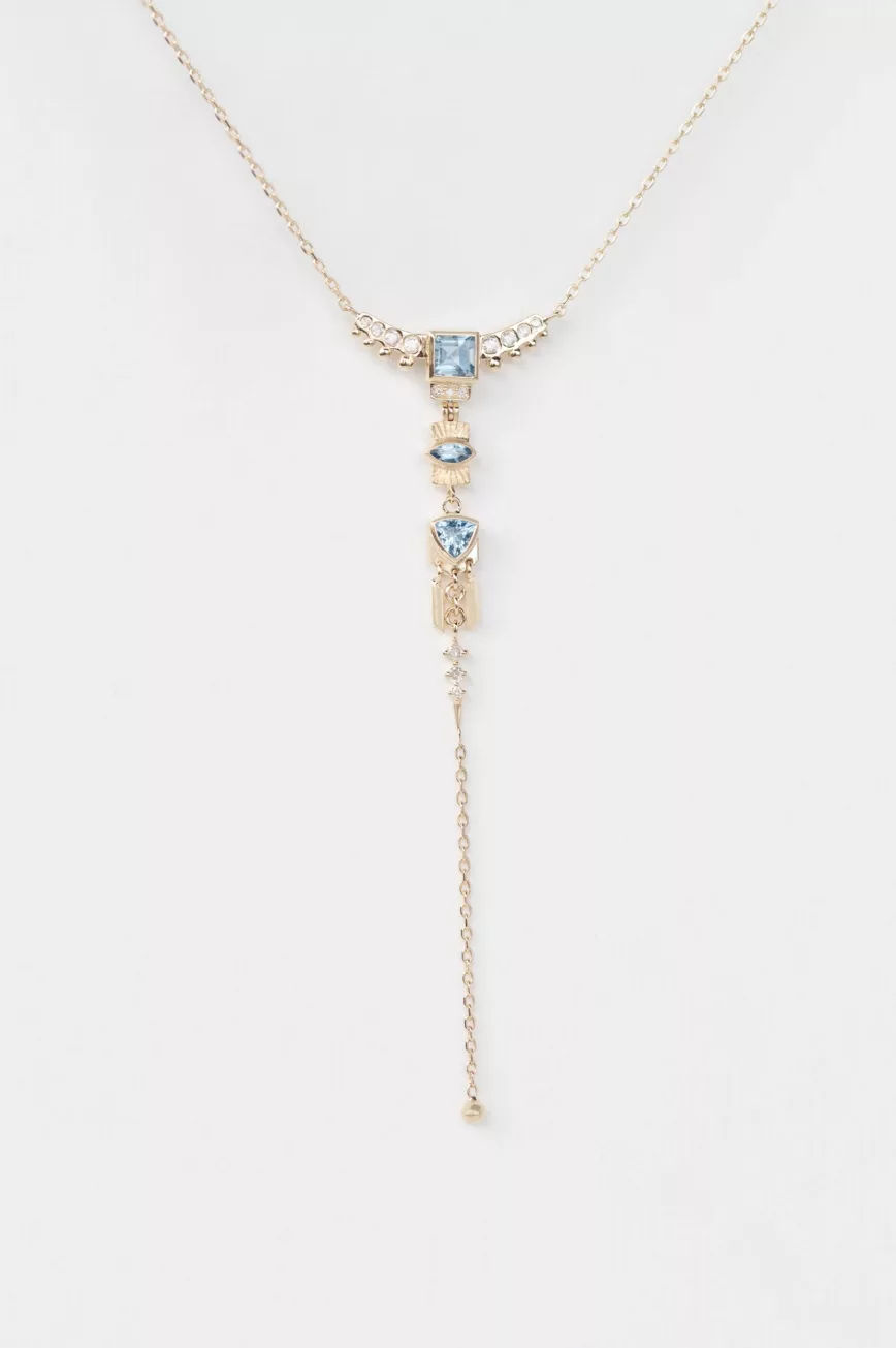 Yellow gold lariat necklace layered chains aquamarine diamond totem charms drop chain Celine Daoust