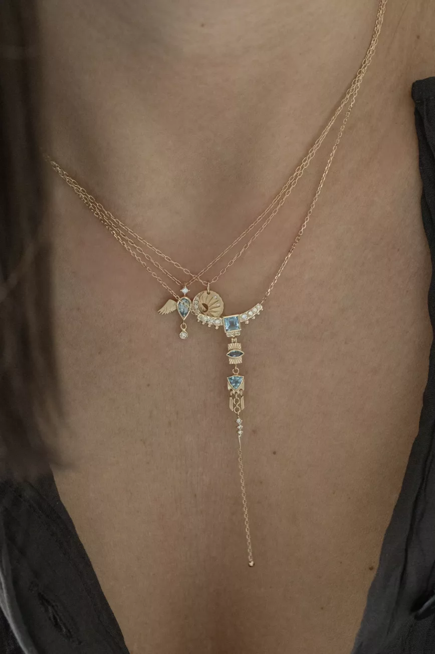 Yellow gold lariat necklace layered chains aquamarine diamond totem charms drop chain Celine Daoust