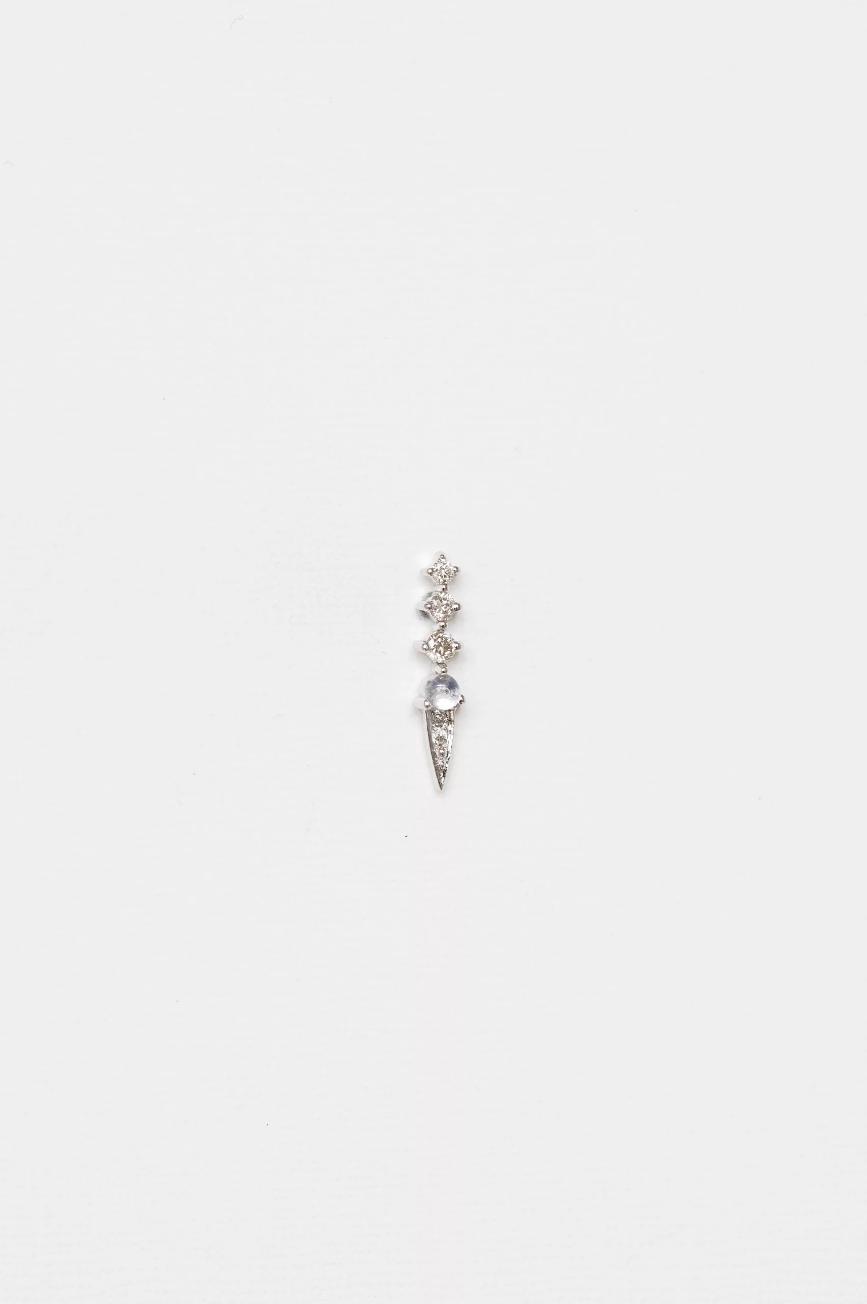 white gold single drop earring featuring a small round moonstone cabochon set in gold with two descending diamond accents, delicate and asymmetric