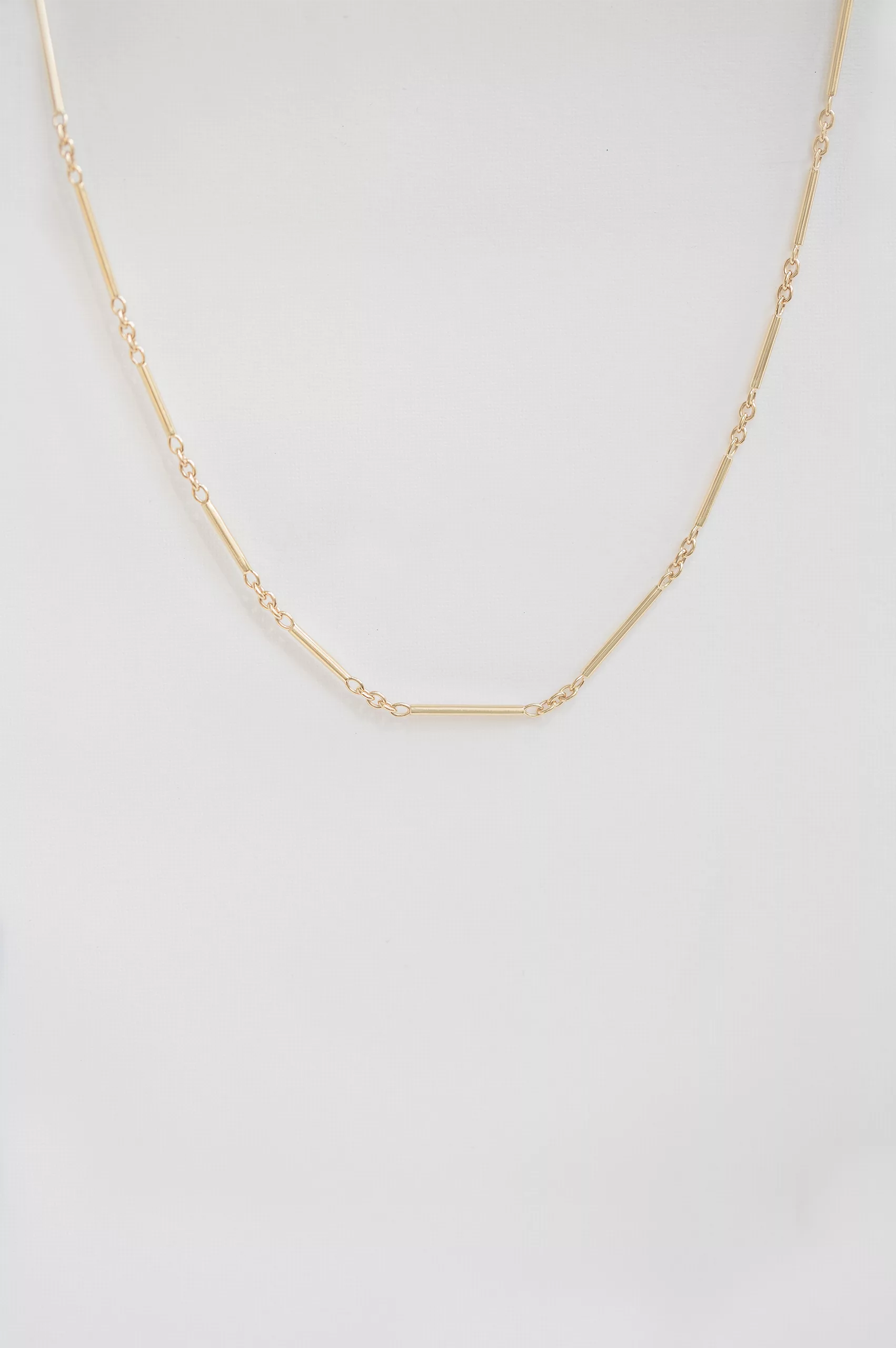 Yellow gold tube chain necklace worn on neck Celine Daoust